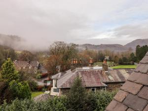 a village with houses and mountains in the background at Garth Hill House in Ambleside