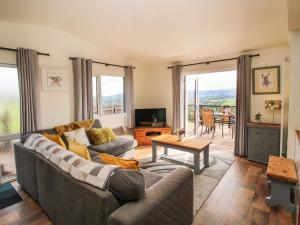 a living room with a couch and a table at Dragonfly Lodge in Shrewsbury