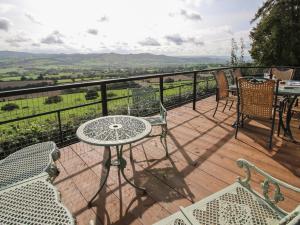 a balcony with a table and chairs and a view at Dragonfly Lodge in Shrewsbury