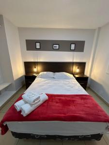 圣萨尔瓦多德朱Apartamentos El Fortín的一间卧室，有一张大床，床上有两条毛巾
