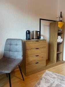 a desk with a chair and a dresser with a microwave at Ferienhaus Koch Weißbriach in Weissbriach