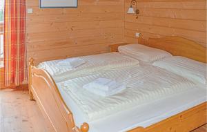two beds in a wooden room with towels on them at Stunning Home In St, Stefan With 3 Bedrooms And Sauna in Elsenbrunn