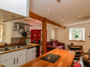 cocina con encimera de madera y mesa en Gun Powder Cottage, en Tighnabruaich