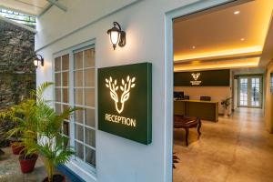 an office lobby with a retention sign on the wall at Makayiram Retreat in Munnar
