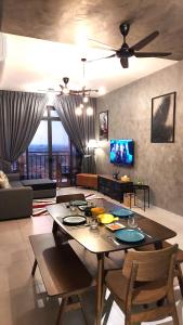 a living room with a table with chairs and a ceiling fan at Rustic Retreat 3R2B Infinity Pool/Wifi/Jonker 8min in Melaka +23 photos