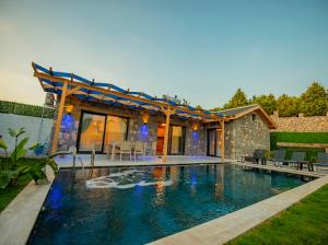 a house with a swimming pool in the yard at Villa Ege & villa yiğit & villa yağız - happy villaları in Fethiye