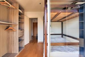 a bedroom with a bunk bed and a closet at Vacances au pied de la plage du Val-André in Le Val-André