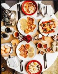 a table with plates of breakfast food on it at By nora in Strasbourg