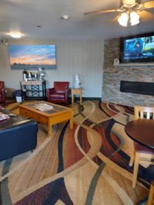 a living room with a couch and a coffee table at Days Inn & Suites by Wyndham Fargo 19th Ave/Airport Dome in Fargo