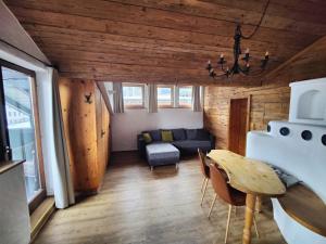 a living room with a table and a couch at Appartement Schönpflug in Kaprun