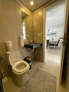 a bathroom with a toilet and a view of a room at Luxury Experience in Asunción: Fully Equipped in Asunción