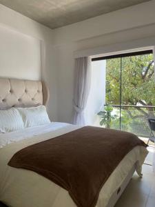 a bedroom with a large bed with a large window at Luxury Experience in Asunción: Fully Equipped in Asunción