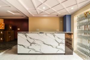 a large marble screen in a room with a wall at Capital O N R Residency in Bengaluru +30 photos