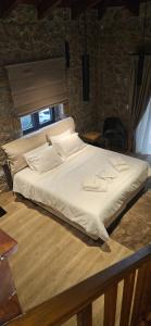 a large bed sitting on top of a wooden table at Miltilon in Synikia Mesi Trikalon