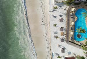 an overhead view of a beach with chairs and the water at Dream of Zanzibar Resort & Spa - Premium All Inclusive in Uroa