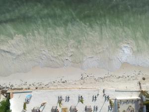 an overhead view of a beach with chairs and the ocean at Dream of Zanzibar Resort & Spa - Premium All Inclusive in Uroa