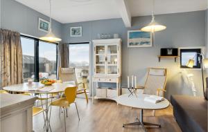 a kitchen and living room with two tables and chairs at Fan Bad, Lejl, 50 in Fanø