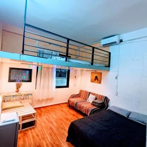 a living room with a bed and a couch at Private Homestay 402 Lily's house 2 beds in city center in Ho Chi Minh City