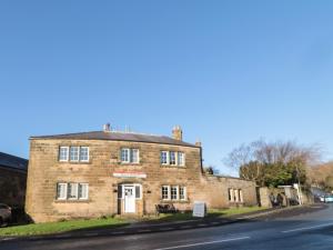 an old brick building on the side of a road at Victoria House in Belford