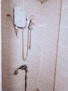 a shower in a bathroom with a shower head on a wall at Private Homestay 402 Lily's house 2 beds in city center in Ho Chi Minh City +8 photos