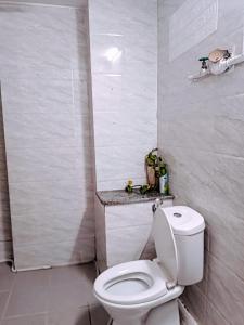 a bathroom with a white toilet in a room at Private Homestay 402 Lily's house 2 beds in city center in Ho Chi Minh City