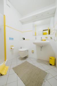 a white bathroom with a sink and a toilet at Ferienhaus Schöne Aussicht Ferienwohnung Gelb in Hemfurth-Edersee