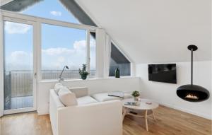 a living room with a white couch and a fireplace at Beautiful Home In Skagen With Wifi in Skagen