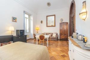 a living room with a table and a couch at Liberty Suite in Turin