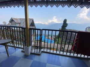 a balcony with a view of a pool at Backpackers Hub in Darjeeling