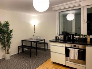 a kitchen with a counter and a table and a table at Spacious Room with City Skyline Views close to London Eye in London