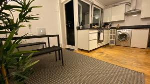 a kitchen with a washer and dryer in a room at Spacious Room with City Skyline Views close to London Eye in London +9 photos