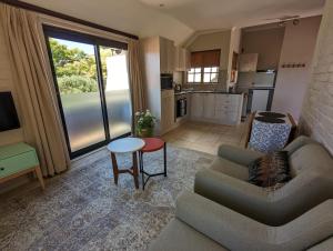 a living room with a couch and a table at 33 Longifolia in Stellenbosch