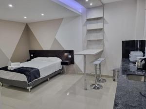 a bedroom with a bed and a desk in it at Suite La Posta in San Salvador de Jujuy