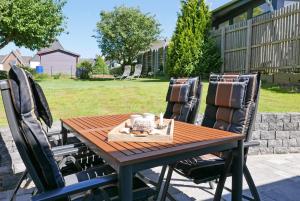 a wooden table and chairs on a patio at Borbyer Perle in Eckernförde