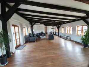 a large living room with wooden floors and windows at Über dem Kattsund in Eckernförde +11 photos