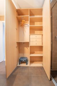 a walk in closet with a blue stool in it at Joli studio centre Cannes in Cannes