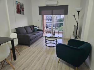 a living room with a couch and a table at Takelena Apartments in Limassol