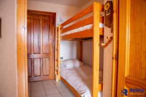 豐羅穆的住宿－L'églantine，一间卧室设有两张双层床和一扇门