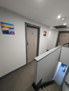 an empty office with a staircase and a door at Sussex Apartments 26B in Grimsby