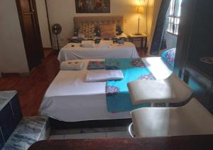 a bedroom with a large bed with white sheets at Casa hotel Mi Huila in Neiva