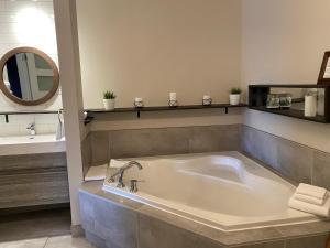 蒙馬尼的住宿－維爾中央酒店，设有带大浴缸及镜子的浴室