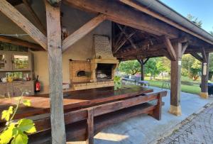 an outdoor kitchen with a large wooden table at La Maladire- Saint Martin Du Lac Burgundy 
