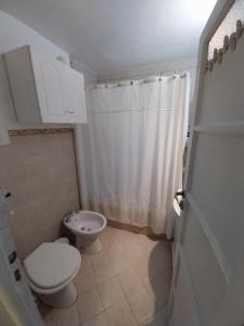 a small bathroom with a toilet and a sink at Hospedaje en San Isidro in San Isidro +20 photos