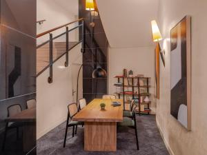 a room with a table and chairs and a staircase at Mercure Paris Gare Montparnasse TGV in Paris