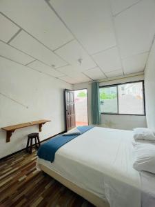 Postel nebo postele na pokoji v ubytování Hostal Darwin