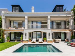 an exterior view of a house with a swimming pool at Villa Coste Simons Town in Simonʼs Town