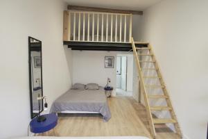 a bedroom with a bunk bed and a ladder at Orly Serenity House Paris 20min Aéroport 12min Parking gratuit in Orly