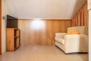a living room with a white couch and wooden walls at SE034 - Senigallia, graziosa mansarda con vista mare in Senigallia