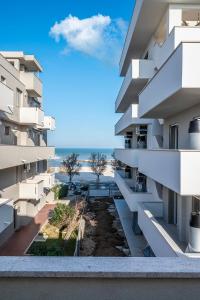 a view of the beach from the balcony of a building at SE034 - Senigallia, graziosa mansarda con vista mare in Senigallia