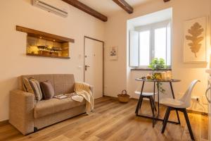 a living room with a couch and a table at Ginevra Home in Monterosi +25 photos